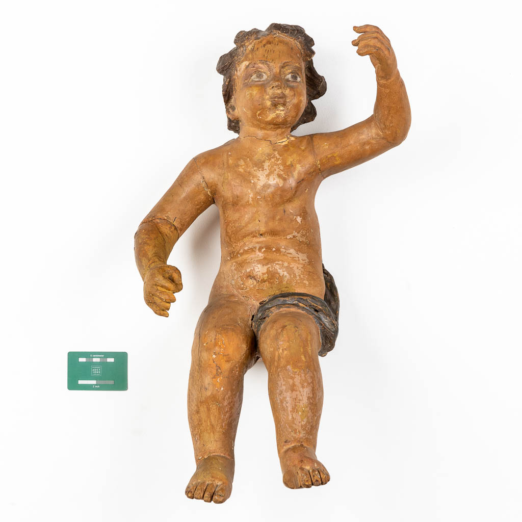 An antique figurine of a putto, sculptured and patinated wood. 18th C. (L:35 x W:34 x H:67 cm) - Image 2 of 12