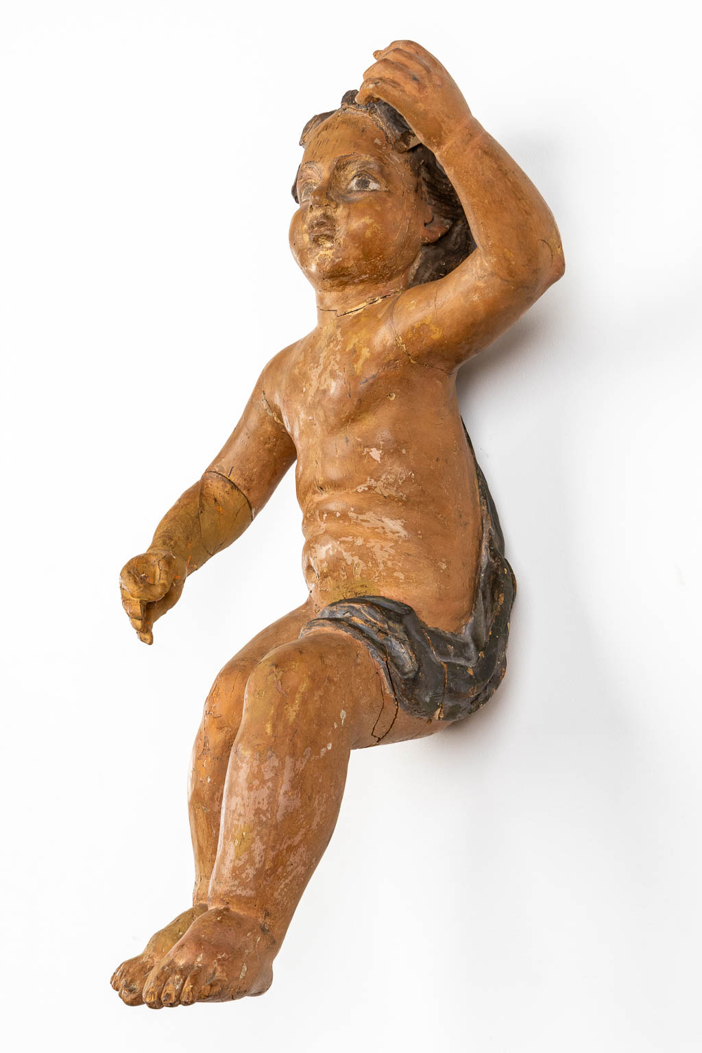 An antique figurine of a putto, sculptured and patinated wood. 18th C. (L:35 x W:34 x H:67 cm) - Image 3 of 12