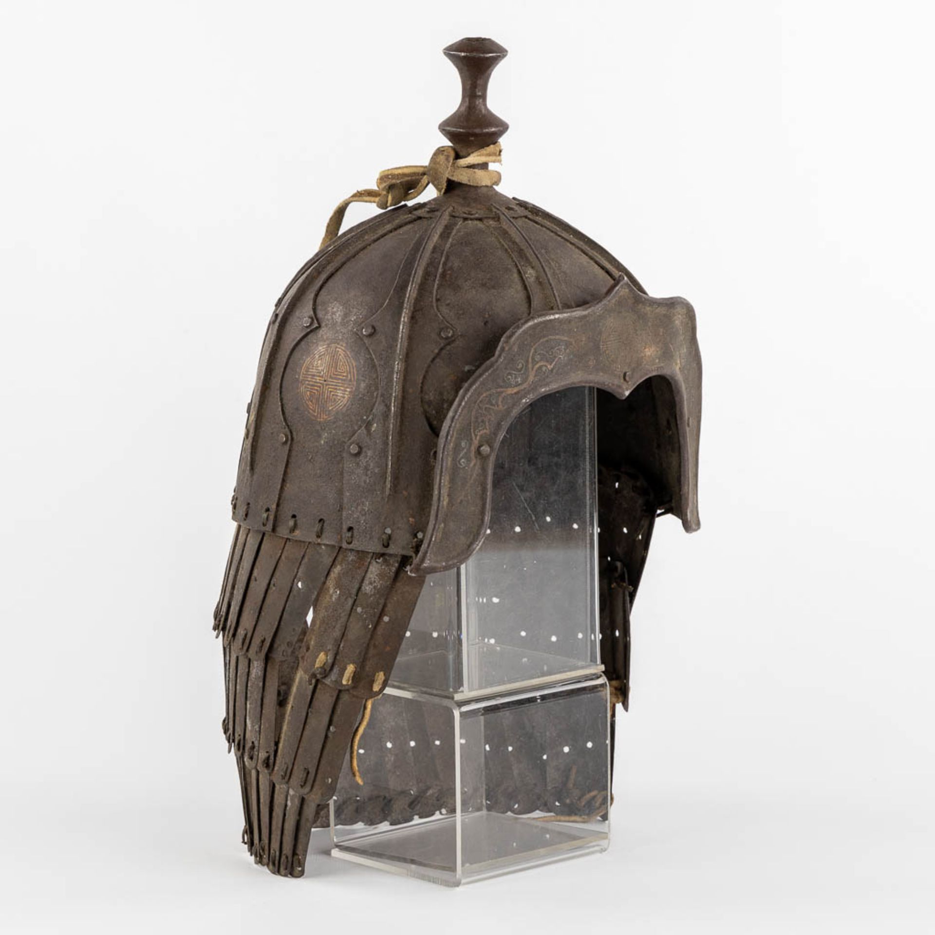 A Tibetan military helmet, iron and leather. 18th/19th C. (L:20 x W:24 x H:42 cm)