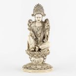 A Chinese Buddha holding a Ruyi and Buddha, sculptured ivory. Circa 1900. (L:10,5 x W:12,5 x H:25,5 