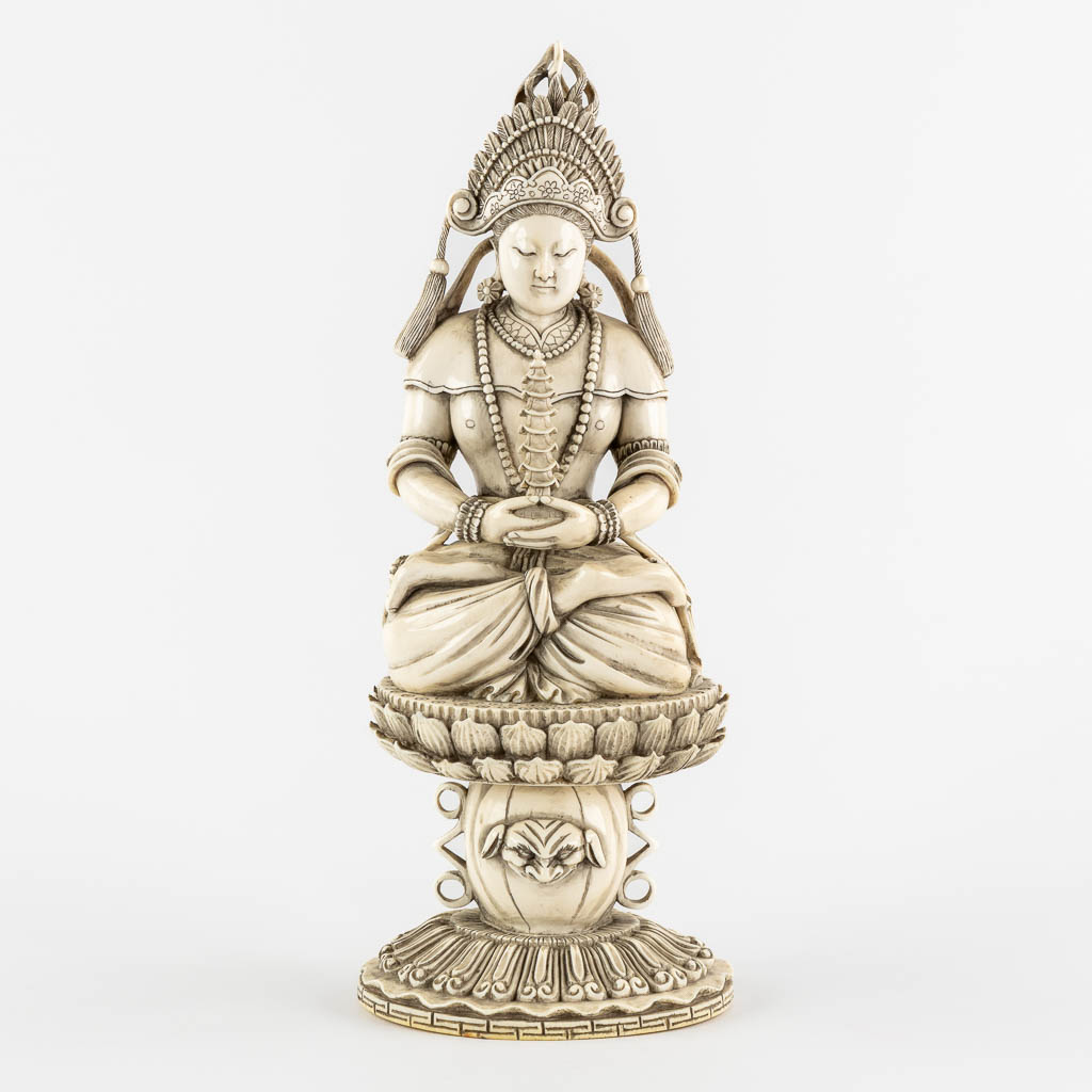 A Chinese Buddha holding a Pagoda, sculptured ivory. Circa 1900. (L:10 x W:12 x H:31 cm)