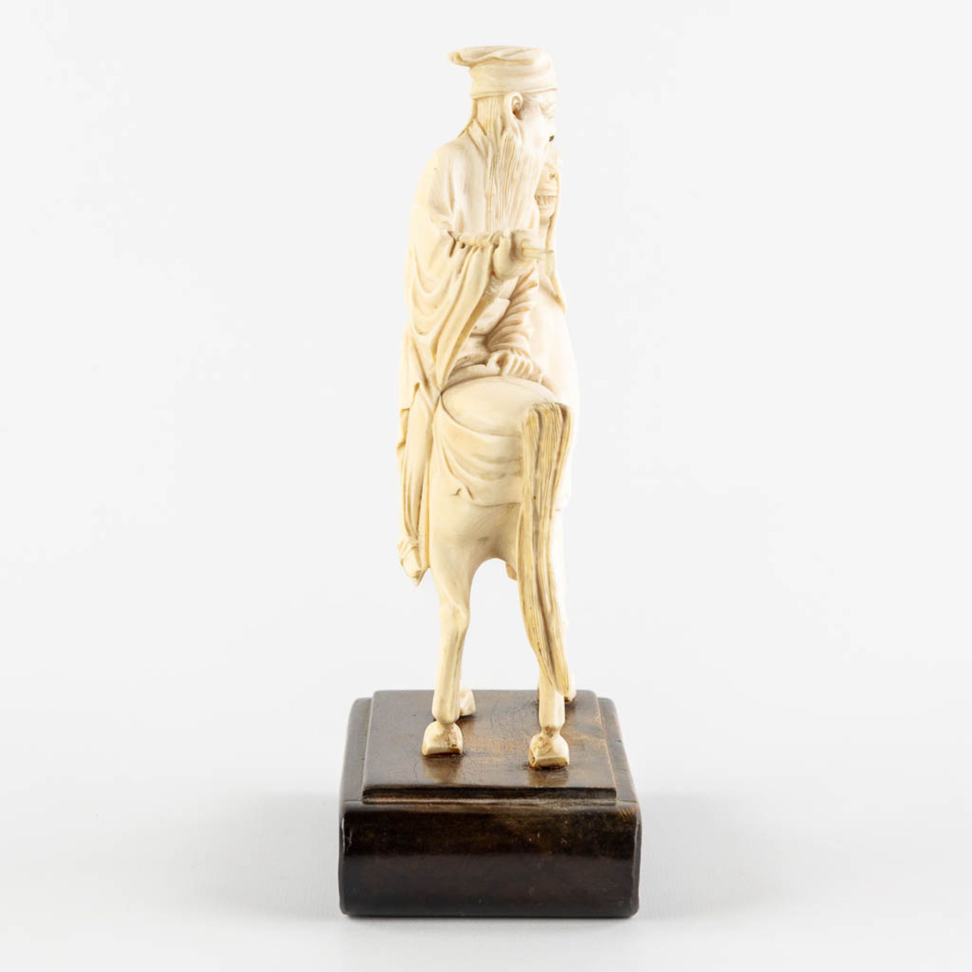 A Chinese sculptured figurine of Zhang Guolao, one of the eight immortals, ivory. (L:6 x W:12 x H:20 - Image 6 of 10