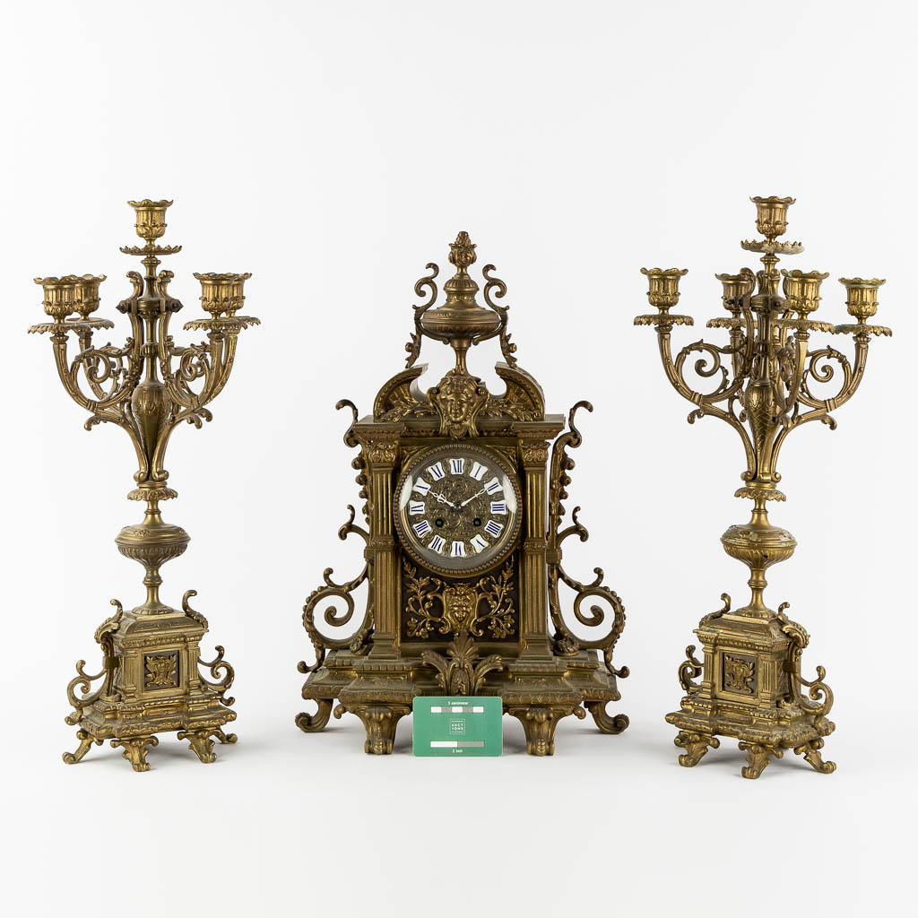 A three-piece mantle garniture clock and candelabra, patinated bronze. (L:16 x W:33 x H:50 cm) - Image 2 of 13