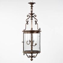 A large lantern, patinated metal and glass. Circa 1900. (H:144 x D:45 cm)