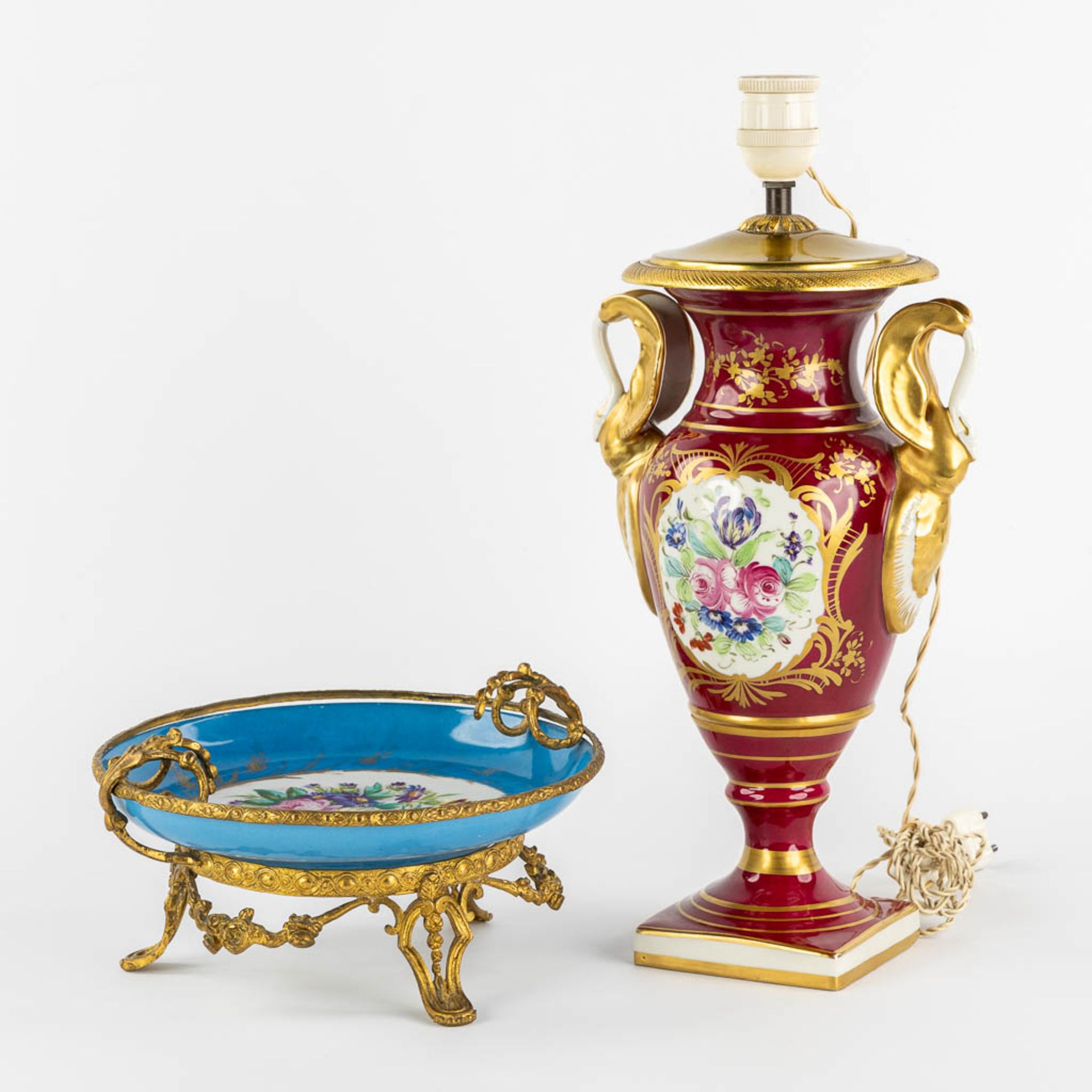 Limoges and Sèvres marks, a lamp base and a tazza with a hand-painted flower decor. (H:40 cm)