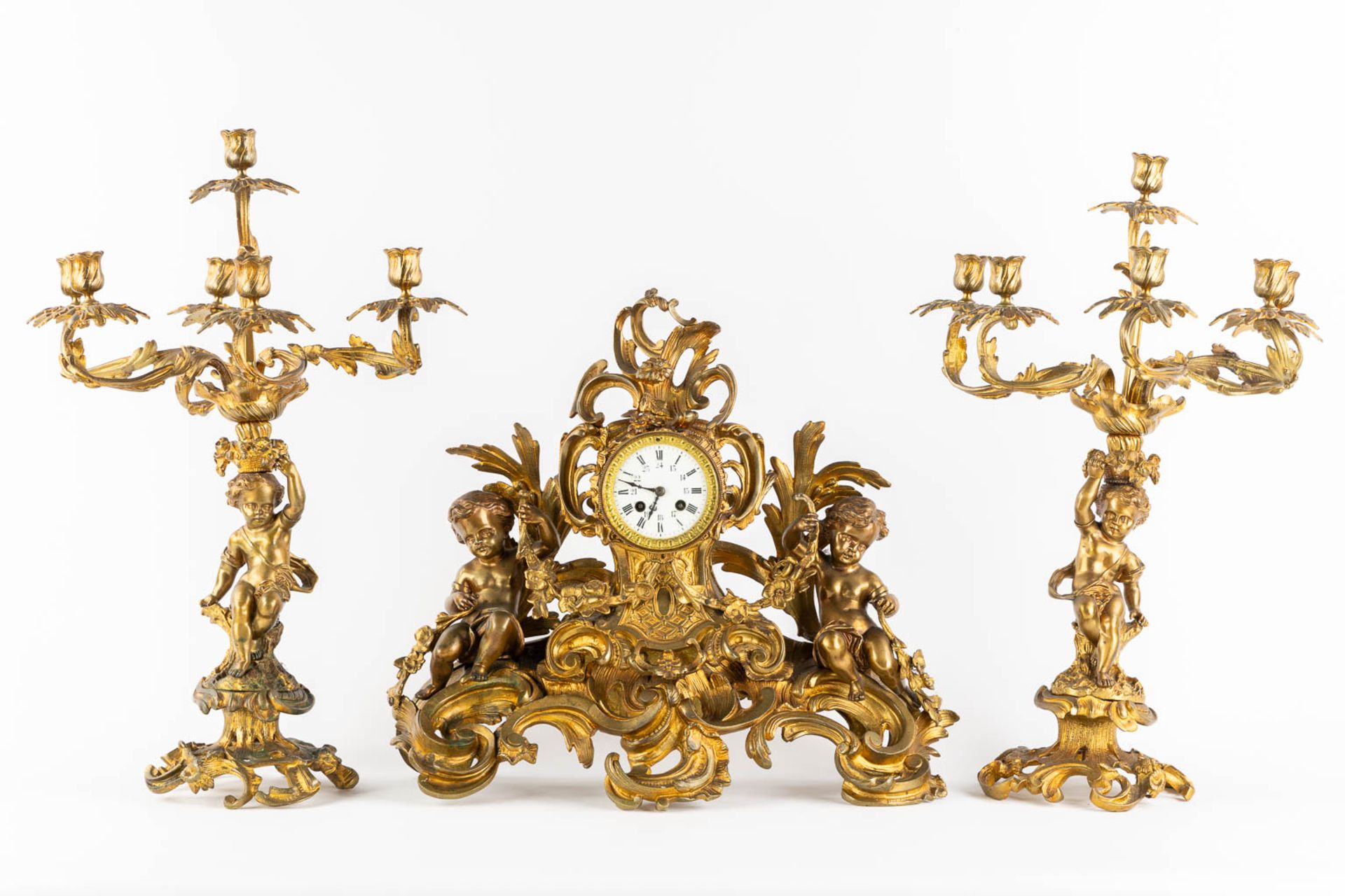A three-piece mantle garniture clock and candelabra, gilt bronze. 19th C. (L:21 x W:55 x H:48 cm) - Image 3 of 16