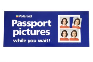 A Polaroid Passport Pictures Whilst You Wait Sign,