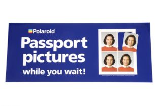 A Polaroid Passport Pictures Whilst You Wait Sign,