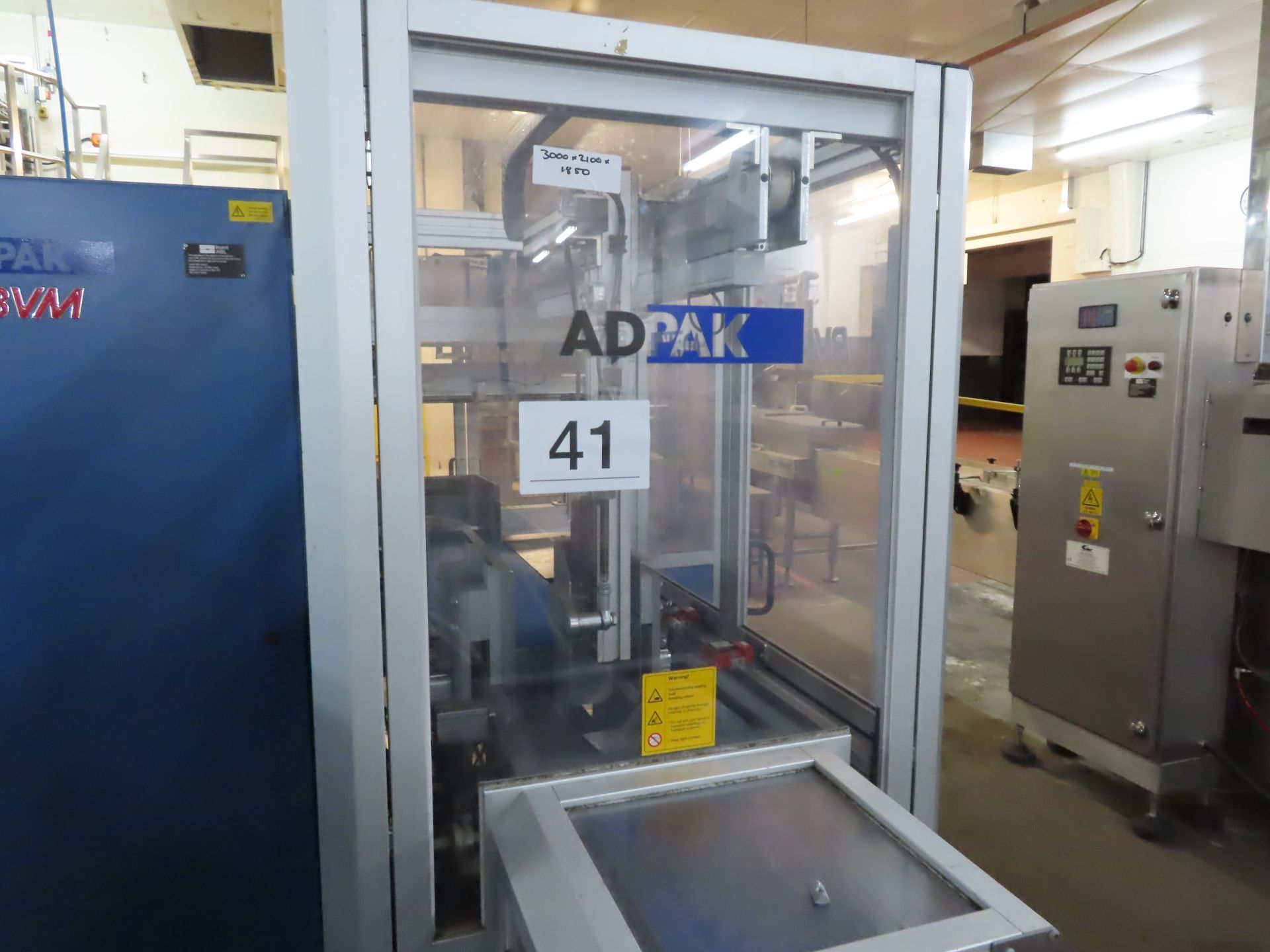 ADPAK SLEEVE WRAPPING MACHINE.