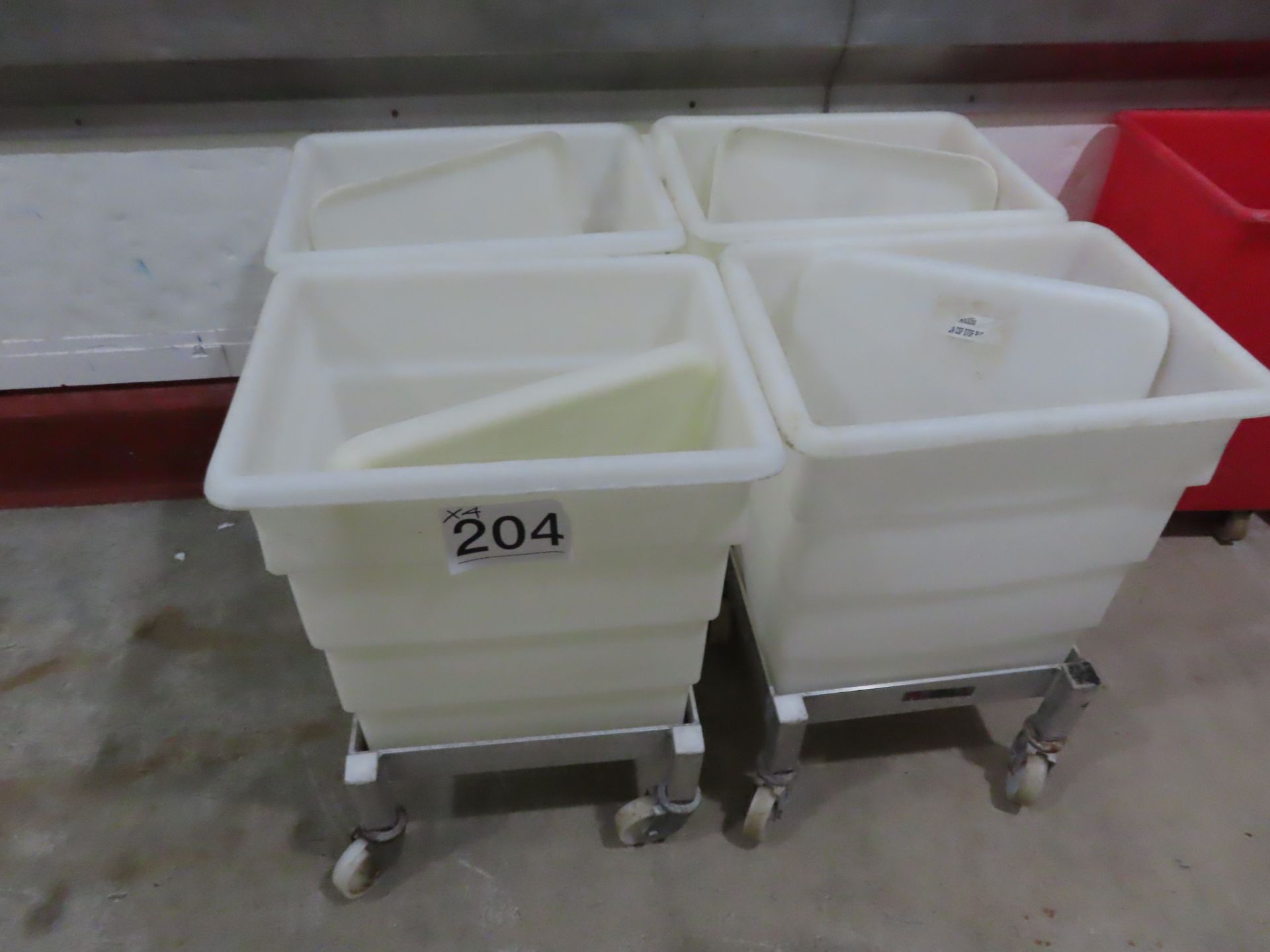 4 X WHITE PLASTIC BINS WITH LIDS ON SYSPAL DOLLIES.