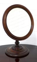 Mahogany dressing table mirror, circular glass plate within a moulded frame , raised on a knop