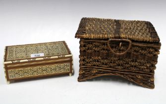 Wicker sewing basket containing vintage cotton threads together with an Eastern inlaid musical