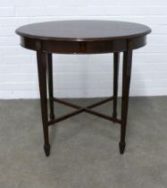 An Edwardian mahogany table, the oval top on square tapering legs and cross stretcher, 77 x 72 x