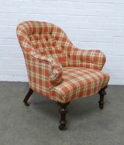 An upholstered button back armchair with mahogany legs and brass castors, , 65 x 76 x 52cm.