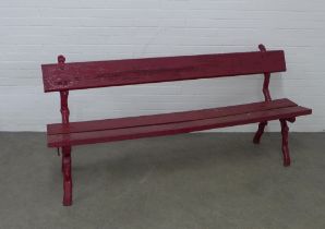 Red painted garden bench with naturalistic cast iron supports and wooden seat and backrest, 193 x 87