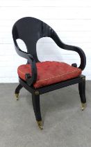 An ebonised Roman chair in the Empire manner with curved back and cane seat, separate upholstered