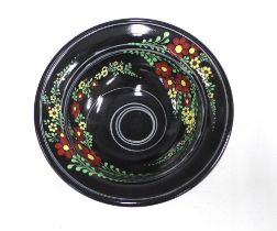 American art pottery bowl, the black glazed ground with flowers in coloured enamels, 25 x 9cm.