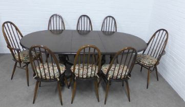 Ercol dark elm dining suite comprising an oval extending table and set of eight Quaker model 365