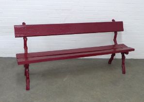 Red painted garden bench with naturalistic cast iron supports and wooden seat and backrest, 193 x 87