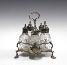George III silver cruet stand with a set of five matched glass condiment bottles with white metal