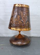 Large copper table lamp and shade, embossed with African figures, 74cm