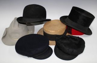 Vintage hat box containing a collection of felt caps and hats to include a bowler and top hat, etc