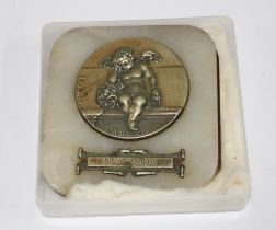 French hardstone paperweight mounted with a white metal "D'Apres N. Blasset" cherub plaque, 8.5 x
