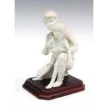 Kaiser bisque pottery father and son figure group, on a wooden plinth, printed factory marks, 12 x