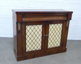 Regency rosewood side cabinet, rectangular top over two glazed and fabric lined doors with gilt