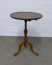 Mahogany wine table, circular top with dished edge, on pedestal base with tripod legs, 48 x 63cm.