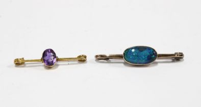 Two early 20th century yellow metal bar brooches to include an opal brooch and an amethyst brooch (