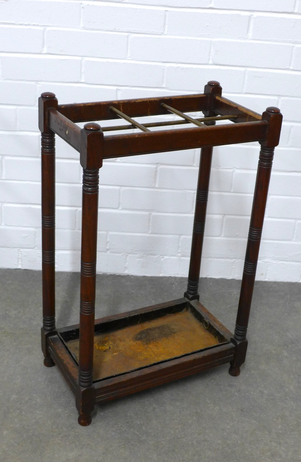 Mahogany stick stand, with six brass divisions and original metal drip tray, 45 x 71 x 26cm.