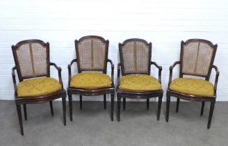 Set of four French bergere open armchairs, caned back and seats with loose cushions, on fluted legs,