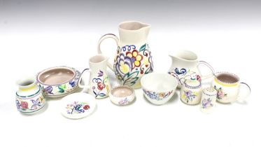 A collection of Poole Pottery, floral decorated in coloured enamels, to include jugs, cruets and