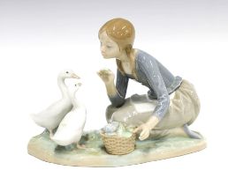 Lladro figure of a girl feeding two geese, printed backstamp, 23 x 18cm.