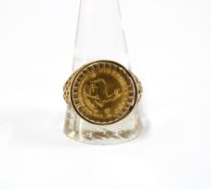 A 1/10 Krugerrand 1984 coin in a 9ct gold ring setting with hallmarks for Birmingham 1985 (setting