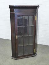 Simulated mahogany corner cupboard, glazed door with shelved interior and pine planked back, 57 x