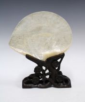 Chinese carved abalone / mother of pearl shell on stylised wooden stand, 24 x 19cm.