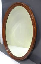 A mahogany wall mirror with an oval bevelled edge plate, 93 x 60cm