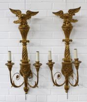 A pair of giltwood wall lights with eagle surmounts and twin branches (2) 33 x 85cm.