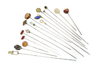 A collection of hat pins to include a Birmingham silver example , various hardstone pins and another
