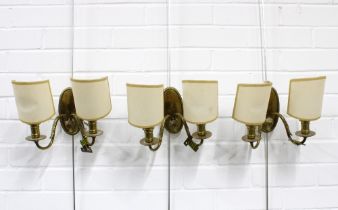A set of three brass wall lights with twin branches and shades (3) 22 x 16cm.