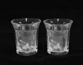 A pair of Lalique 'Les Enfants' clear and frosted liqueur or shot glasses, signed and boxed (2) 4
