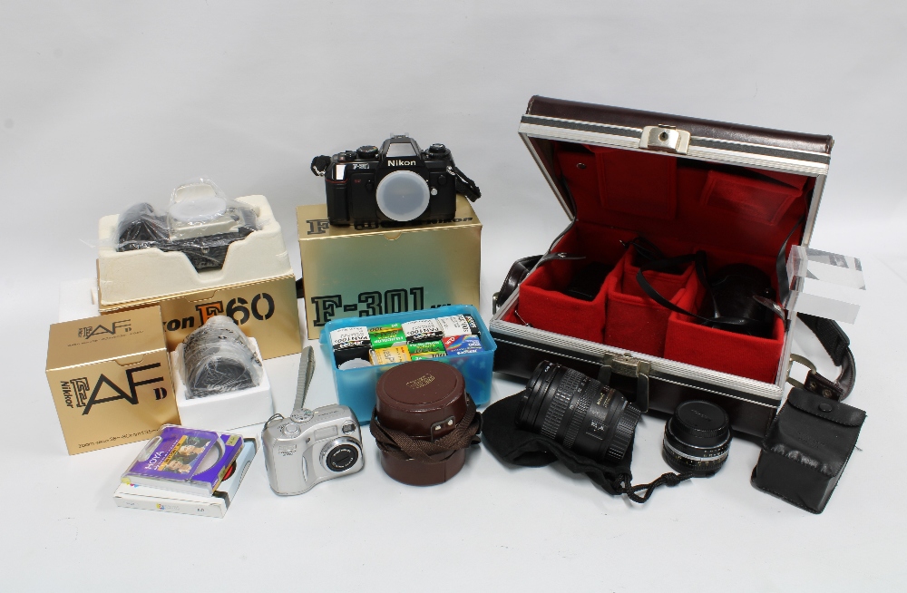 A quantity of vintage cameras and equipment, including Nikon F-301, F60, a carry case containing