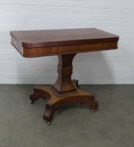 Mahogany tea table, the fold over top with reeded edge, on a waisted square column and quadripartite