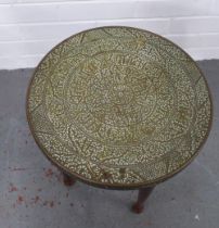 Early 20th century side table, the circular brass top with Islamic style calligraphy, 38 x 39cm.