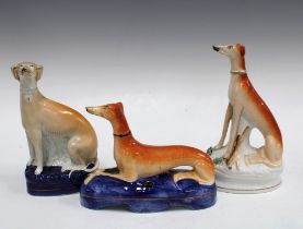 A group of 19th century Staffordshire greyhound figures to include a quill holder, 21cm (3)