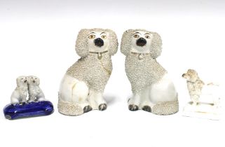 A group of four 19th century Staffordshire poodles with textured clay, (4) (a/f) tallest 12cm