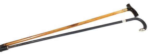 A walking cane with yellow metal mount and faux tortoiseshell handle together with a silver