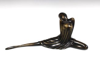 Bronze patinated model of an Art Deco female, modelled seated in short dress, 18 x 49cm